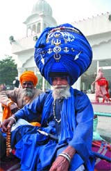 Sikh devotees sit outside Rakab Ganj Gurdwara on the occasion of Martyrs Day in New Delhi