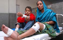 An injured Rupinder Kaur along with her son Tanvir at the civil hospital in Bathinda