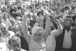 Members of the Joint Action Committee of All Residents Welfare Association block the road in front of DC office in Mohali on Wednesday.