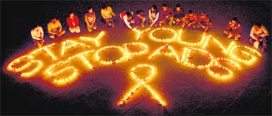 Students of the department of social welfare, Panjab University, light earthen lamps to mark the World AIDS Day, which falls on December 1, in Chandigarh on Wednesday.