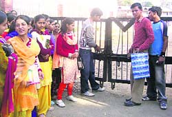 Members of the SCA Arya Government College, Nurpur, locking college gate on Wednesday. 