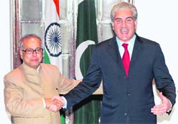Makhdoom Shah Mahmood Qureshi, foreign minister of Pakistan, shakes hands with minister for external affairs Pranab Mukherjee before a meeting at Hyderabad House in New Delhi on Wednesday.