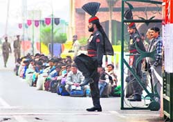 Indians huddle on Pakistans side before crossing over at Wagah-Attari border on Wednesday. 101 Indians were released by Pakistan on Tuesday.