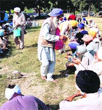 Sugarcane farmers and members of the Bharatiya Kisan Union partake of langar in Chandigarh