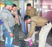 Policemen check luggage at Haridwar railway station.