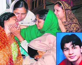 The mother of hotel management student and trainee at the Taj Hotel Gautam Gosai (inset) is consoled by family members in Faridabad