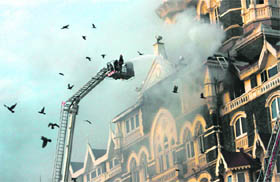 Firemen try to douse flames at Taj Hotel in Mumbai.