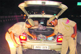 After the Mumbai terror attack, cops check a car at Bikram Chowk in Jammu as part of a security drill on Thursday.