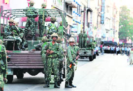 National Security Guard commandos take up positions in the Colaba market area of Mumbai on Thursday.