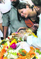 Relatives of Vijay Salaskar express their grief during his funeral in Mumbai on Thursday.