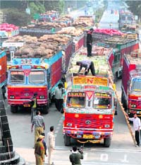 Officials check Pakistan-bound trucks laden with vegetable at the Attari-Wagah border check post, near Amritsar, on Thursday