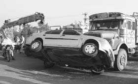 A car that was hit by a truck being taken away in Ambala City