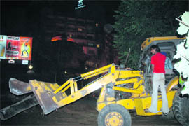 A JCB machine demolishes encroachment by Hotel Park Plaza in Ludhiana on Friday.