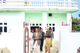 A police team comes out after questioning former SSP, Ferozepur, from his house at Pherurahin village.