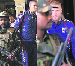 England's captain Kevin Pietersen  and Andrew Flintoff walk to board a bus while Indian security personnel stand alert outside their team hotel in Bhubaneswar