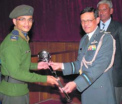 Air Vice Marshal D.C. Kumaria presents the Wavel Sword to Cadet Karthik Reddy in Dehradun on Saturday. 