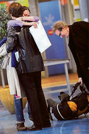 French Kate Chaillat, who escaped the Mumbai attack, is welcomed by her boyfriend and her father at the Roissy Charles-de-Gaulle airport, outside Paris, on Saturday.