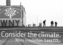Workers adjust a banner on a building prior to the UN climate change conference in Poznan on Saturday.