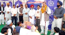Congress candidate Ganga Jal Meel addressing a gathering at Dera Sacha Sauda Naam Charcha Ghar in Suratgarh on Sunday. 