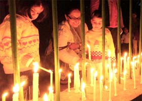 Children light candles at Jantar Mantar in memory of the people who lost their lives in the terror attack in Mumbai, in New Delhi