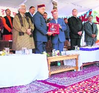 Shanta Kumar welcomes Chief Minister P.K. Dhumal on the occasion of VMRT handover to JayPee Group at Palampur on Sunday. 