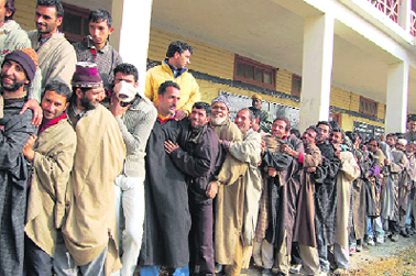 Kashmiri villagers wait in a long queue outside a polling station at Handwara, 80 km from Srinagar.