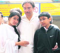 The grief-stricken husband and children of Sabina Sehgal Saikia at her cremation in New Delhi on Sunday. 