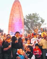 Citizens pay homage to martyrs of the terrorist attacks in Mumbai at the Jallianwala Bagh in Amritsar on Sunday. 
