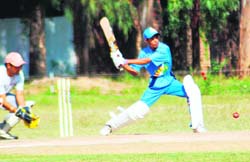A Maharashtra XI batsman tries to hit the ball during their match against Chandigarh XI at Government Model Senior Secondary School, Sector 32, Chandigarh on Monday.
