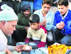 Gaurav, son of martyr Gajendra Singh, performs rituals in Haridwar on Monday. 