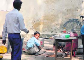 A student prepares mid-day meals for classmates at Government High School, Gandhi Nagar, Jammu