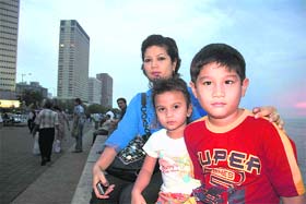 Malaysian national Nur with her children at the Marine Drive with the Trident hotel in the background