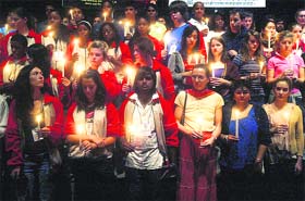 Foreign students hold candles inside a school auditorium in memory of those who were killed in the Mumbai attacks in Lucknow