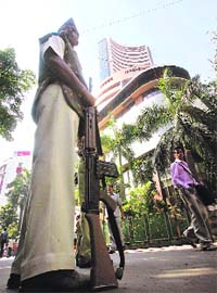 A policeman stands guard in front of the Bombay Stock Exchange building in Mumbai