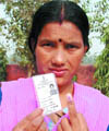 A woman shows her marked finger and voter I-card after casting her vote at Burari in New Delhi on Tuesday.