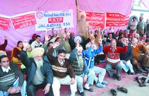 Members of the National Federation of Telecom Employees stage a dharna in Jalandhar on Tuesday.