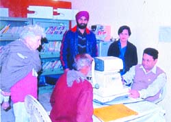 A medical specialist examines a patient at Darshan Academy in Jalandhar.