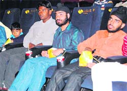 Special children watch a movie during a special screening at a theatre in Ludhiana. 