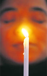 A nun holds a candle during a vigil in New Delhi on Tuesday for the Mumbai terror victims.