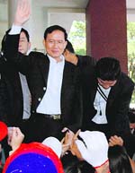 Thai Prime Minister Somchai Wongsawat waves to supporters after a court ruling at his residence in Chiang Mai province, northern Thailand, on Tuesday. 