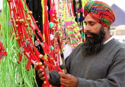 A man choosing a decorative material for his cattle on the eve of the animal fair to be held on the Bathinda-Goniana road