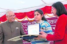 Former Chief Justice of the Supreme Court J.S. Verma felicitates a visually impaired girl at NIVH in Dehradun on Wednesday.