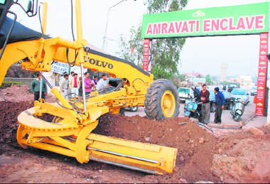 A JCB machine digs up a trench on the road leading to Amravati Enclave on the Panchkula-Pinjore highway near Surajpur on Thursday.