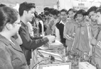 Students look at the functioning of a model during a science exhibition in Ambala on Thursday.