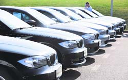 This file photo shows a row of BMW cars at a parking of a BMW dealer. The German luxury carmaker BMW said on Friday the global economic slowdown hit BMW hard in November with unit sales slumping by more than 25 percent compared to the same period last year. Sales of BMW-brand alone cars fell 26 per cent to just under 81,500, the firm said, while Mini sales were down 21 per cent at 15,100. 
