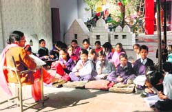 Students attend a class in open sitting on floor at Government Senior Secondary School, Hallo Majra. 