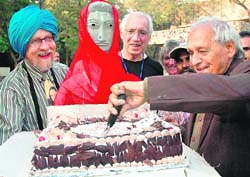 Nek Chand cuts a cake on account of his birthday at Rock Garden in Chandigarh on Saturday. 