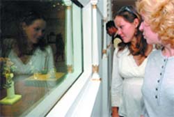 Visitors admire the collection of 'Jewellery of Russian Empire' at an inauguration of 'Faberge' exhibition in New Delhi 