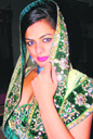 A model displays jewellery and wedding dress during an exhibition in Ludhiana on Friday.