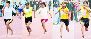 Participants run barefoot in the 100m heat of the Punjab State School Athletics Meet at Guru Nanak Stadium in Ludhiana on Friday.